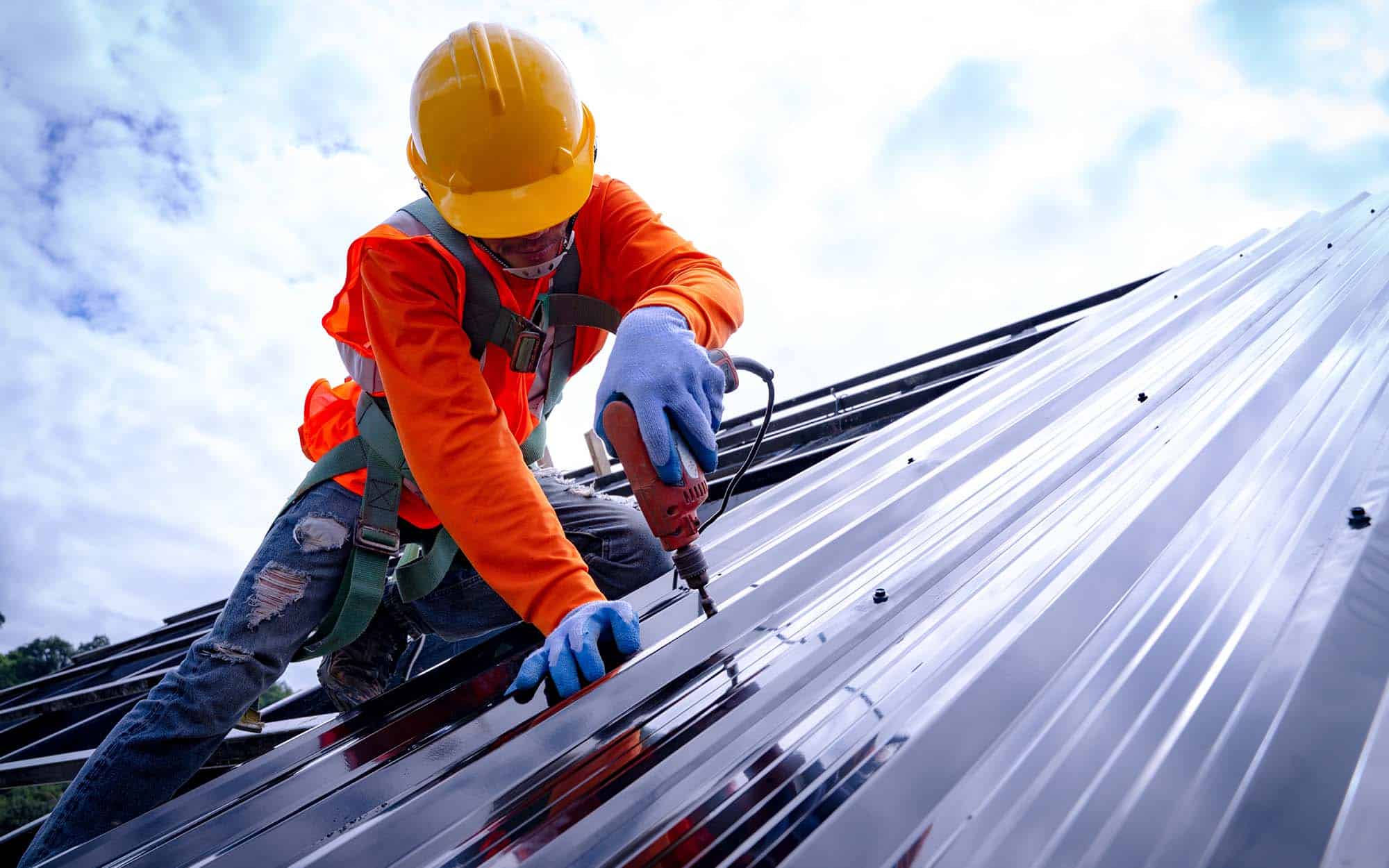 Side-view-of-roofer-repairing-metal-section
